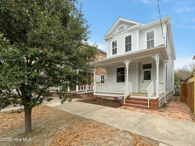 view of front of home featuring cooling unit and covered porch