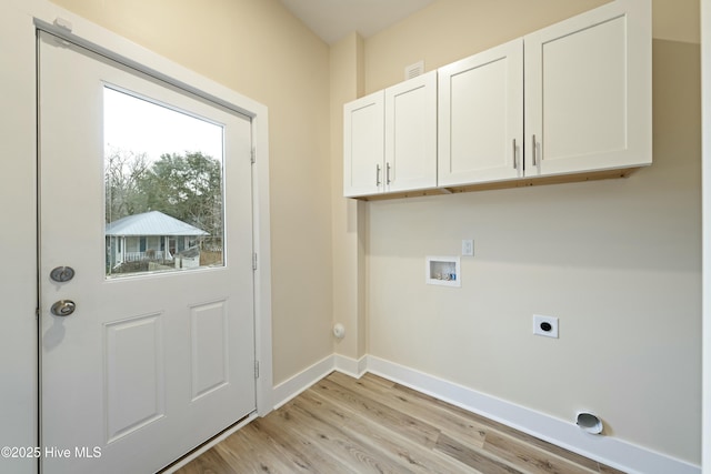 washroom featuring cabinets, washer hookup, light hardwood / wood-style flooring, and electric dryer hookup