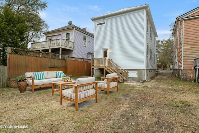 rear view of house featuring an outdoor living space and a lawn