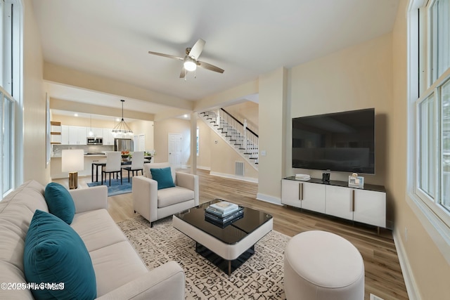 living room with ceiling fan and light hardwood / wood-style floors