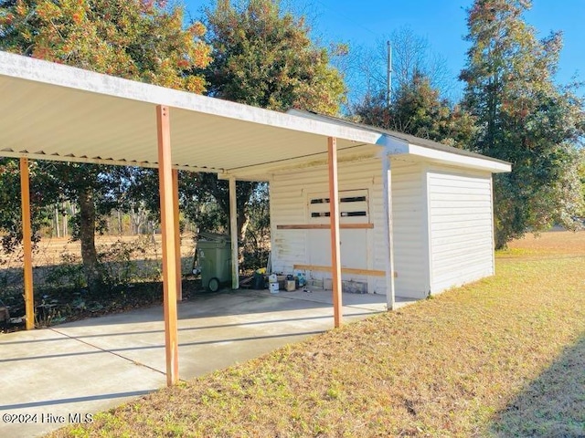 view of parking featuring a carport and a lawn