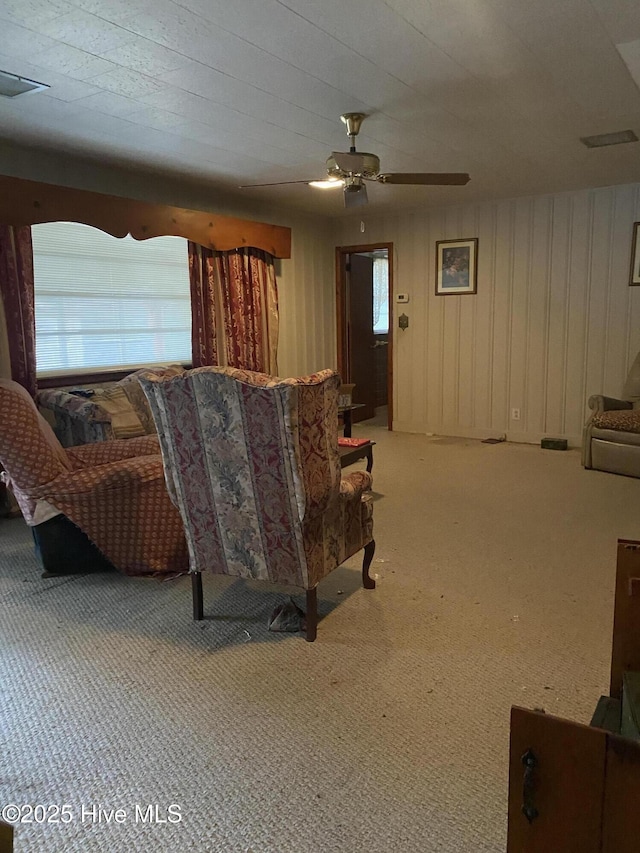 living room featuring light colored carpet and ceiling fan