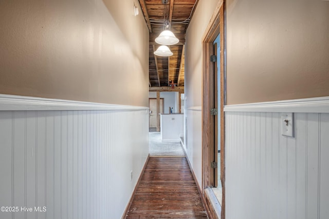 corridor with dark hardwood / wood-style floors and wooden ceiling