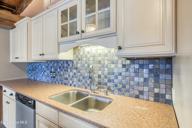 kitchen featuring sink, dishwasher, tasteful backsplash, light stone counters, and white cabinets