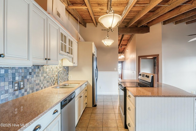 kitchen with hanging light fixtures, sink, white cabinets, and appliances with stainless steel finishes