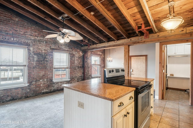 kitchen with stainless steel range with electric stovetop, lofted ceiling with beams, white cabinets, brick wall, and decorative light fixtures