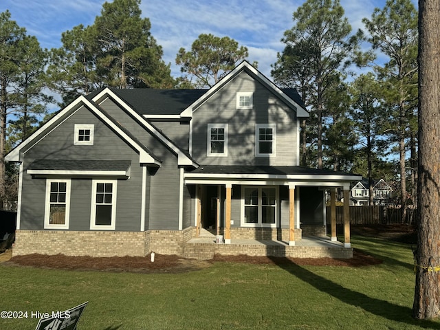 view of front of property with a porch and a front yard