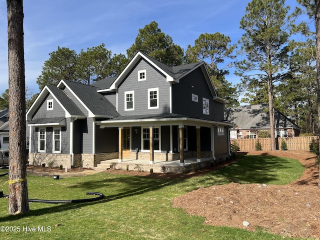 back of house with a patio, roof with shingles, fence, a yard, and brick siding