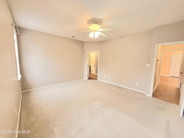 unfurnished room with light carpet and ceiling fan