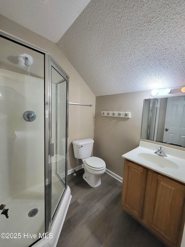 bathroom with vanity, lofted ceiling, toilet, an enclosed shower, and wood-type flooring