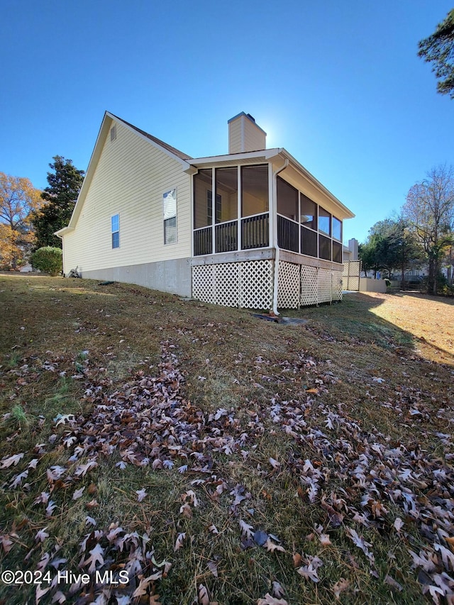 view of property exterior featuring a sunroom