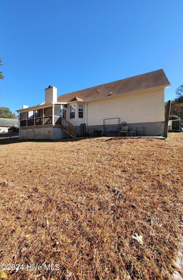 back of house with a sunroom