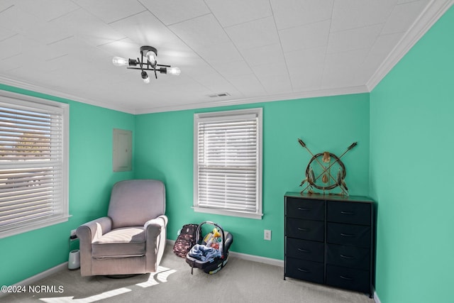 sitting room featuring electric panel, crown molding, carpet floors, and a healthy amount of sunlight