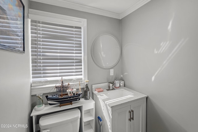 bathroom with vanity, toilet, and crown molding