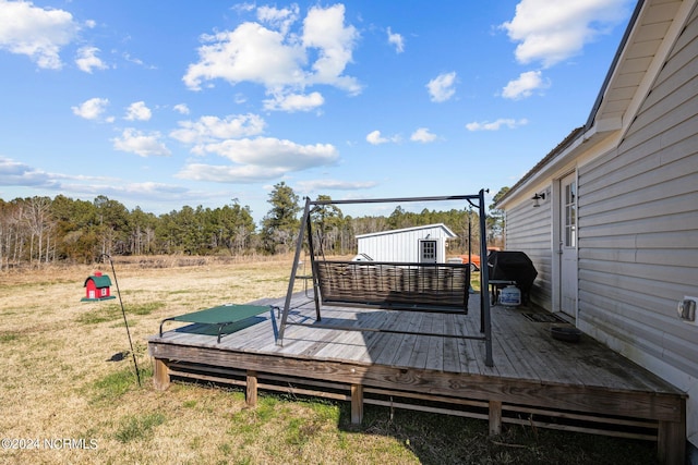 wooden deck featuring a lawn