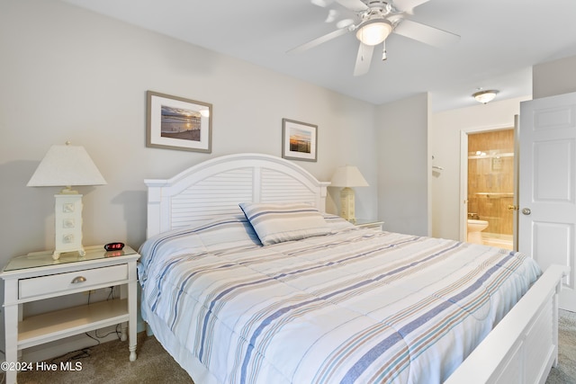 bedroom with dark colored carpet, ceiling fan, and connected bathroom