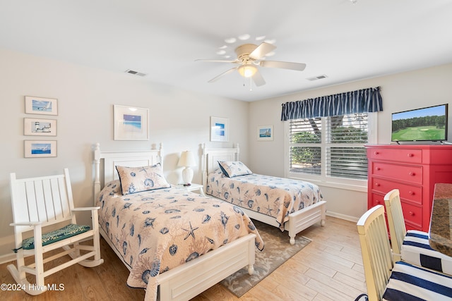 bedroom with ceiling fan and light hardwood / wood-style floors