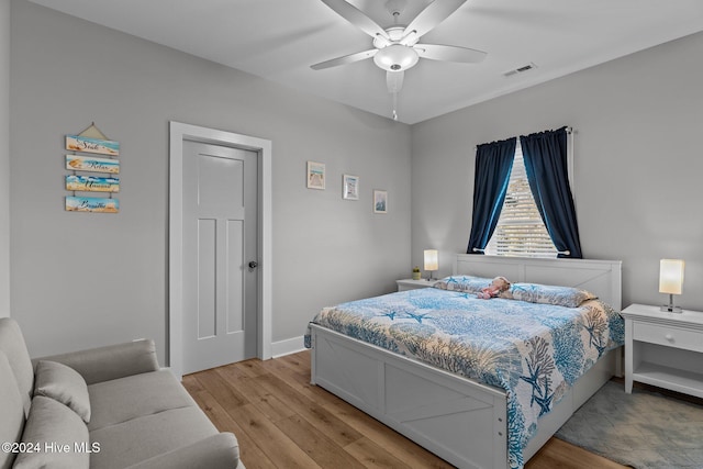 bedroom with light hardwood / wood-style floors and ceiling fan