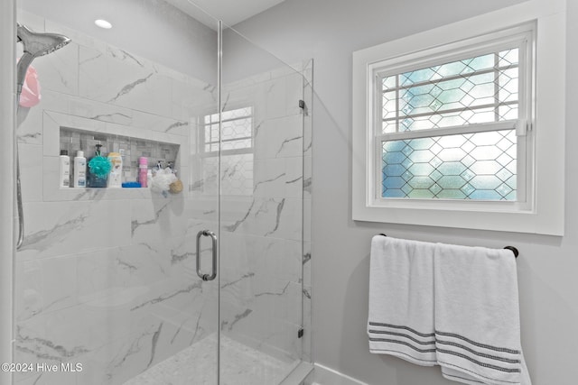 bathroom with a shower with shower door