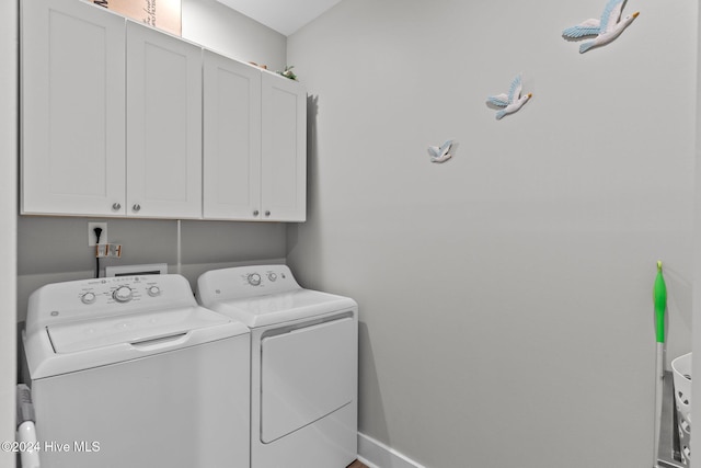 laundry room featuring cabinets and washing machine and clothes dryer