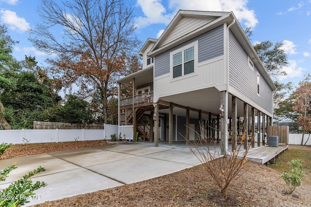 back of property with a carport and central air condition unit