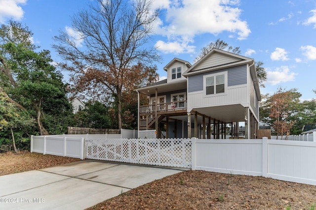 view of front of property with covered porch and a carport