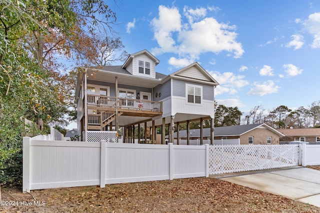 view of front of property with covered porch and a carport