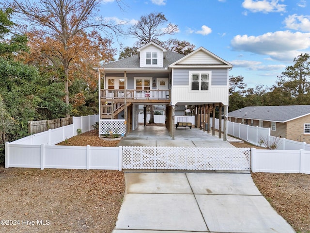 view of front of property with a porch and a carport