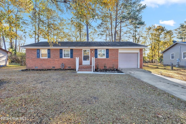 single story home with a front lawn and a garage