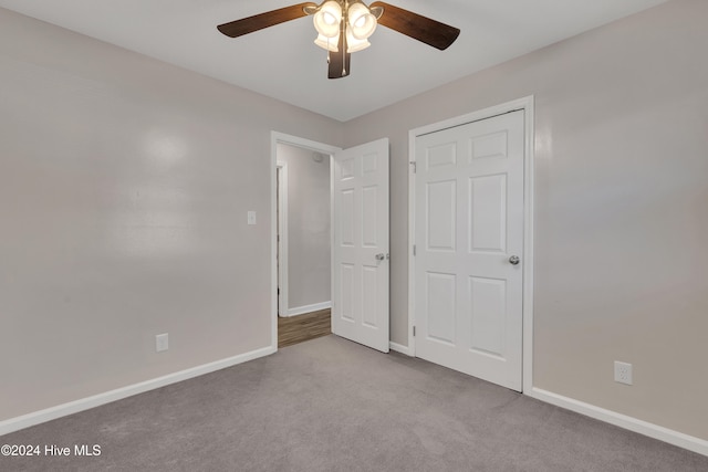 unfurnished bedroom featuring ceiling fan and light colored carpet