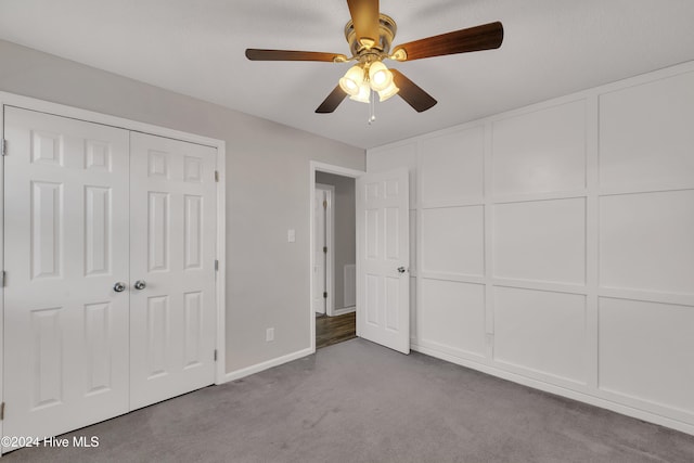 unfurnished bedroom featuring carpet floors, a closet, and ceiling fan