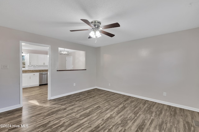 unfurnished room with hardwood / wood-style floors, ceiling fan with notable chandelier, and a textured ceiling