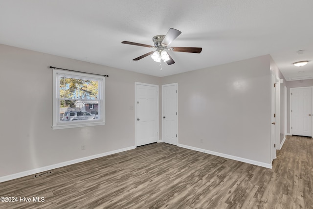 empty room featuring hardwood / wood-style floors, a textured ceiling, and ceiling fan