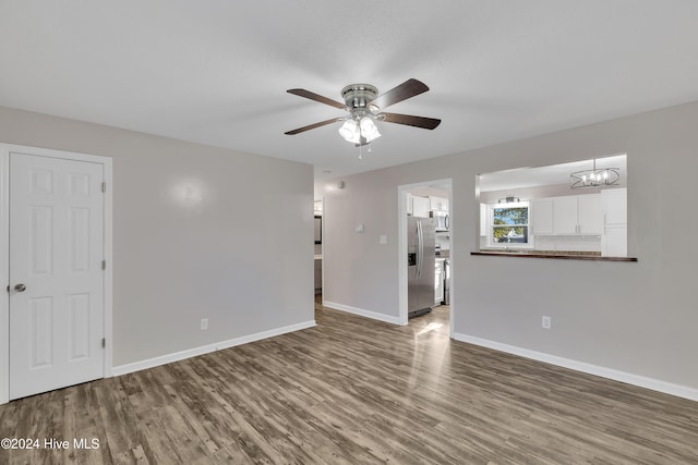 unfurnished living room featuring wood-type flooring and ceiling fan