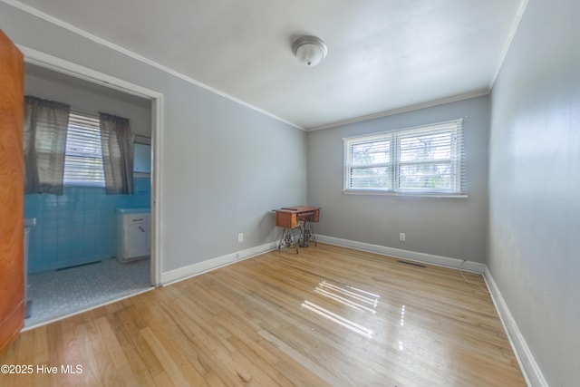 unfurnished room with ornamental molding and light hardwood / wood-style floors