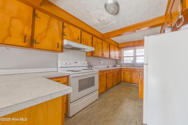 kitchen featuring sink, a textured ceiling, and white appliances