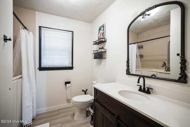 bathroom featuring curtained shower, toilet, and vanity