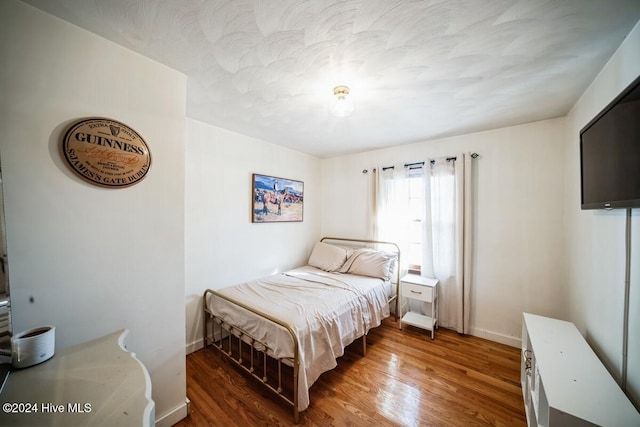 bedroom featuring dark hardwood / wood-style flooring