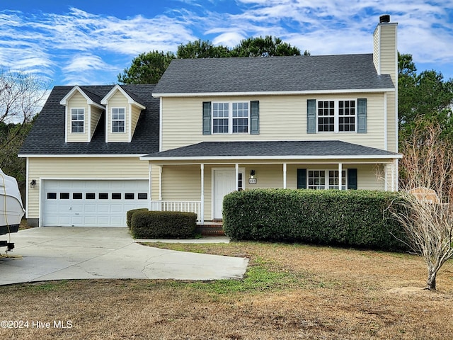 view of front property featuring covered porch and a garage