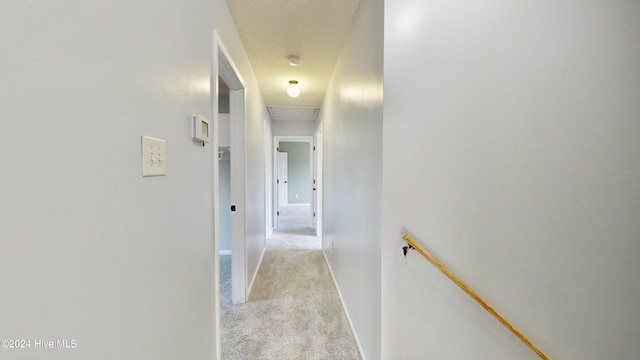 corridor featuring light colored carpet