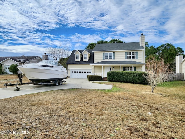 view of front of property with a garage and a front lawn