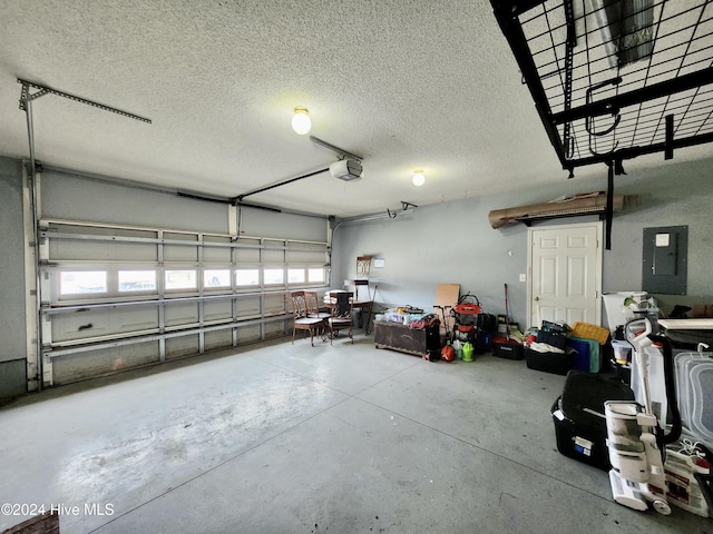 garage featuring electric panel and a garage door opener