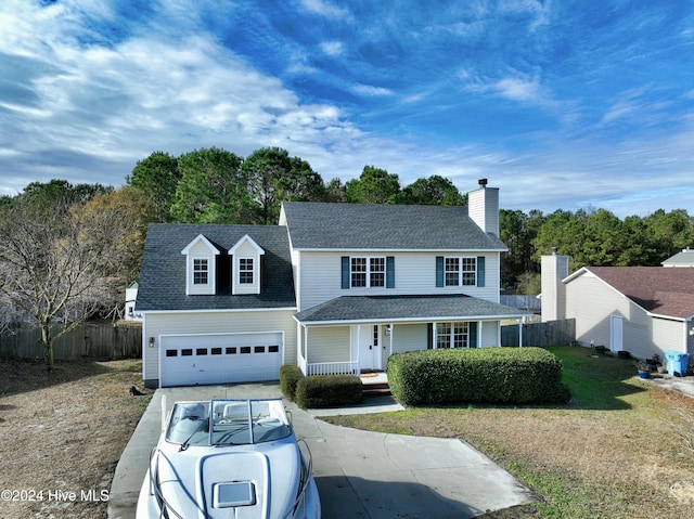 view of front facade with a porch, a garage, and a front lawn