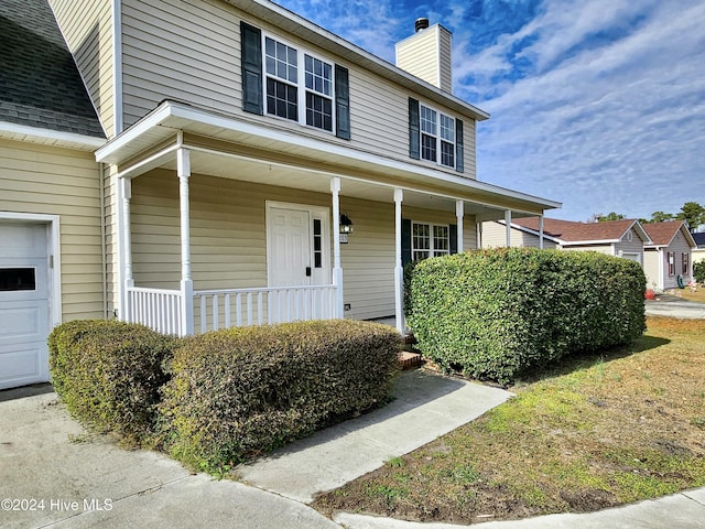 view of front of property with a porch and a garage