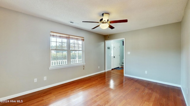 spare room with wood-type flooring, a textured ceiling, and ceiling fan