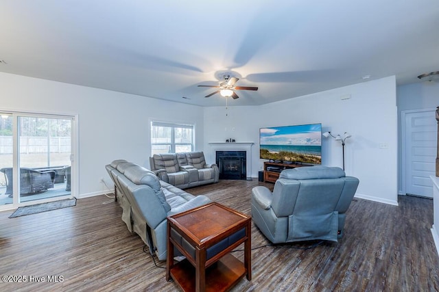 living room featuring ceiling fan and dark hardwood / wood-style floors