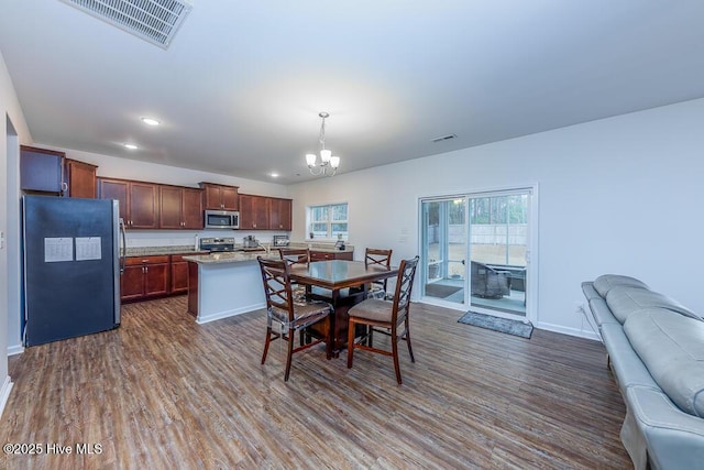 dining room featuring dark hardwood / wood-style flooring and a notable chandelier