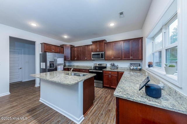 kitchen featuring dark wood-type flooring, light stone countertops, sink, and stainless steel appliances