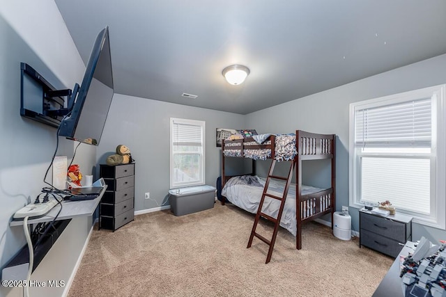 bedroom featuring light carpet