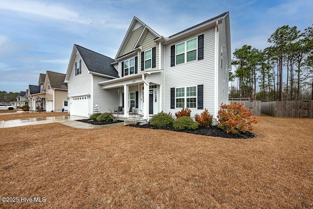 view of front facade with a porch, a garage, and a front lawn